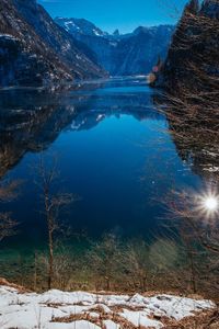 Scenic view of lake and snowcapped mountains during winter