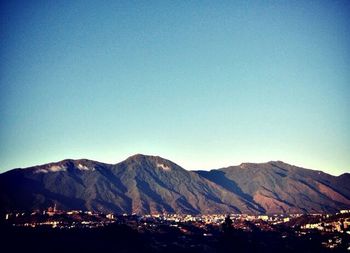 Scenic view of mountains against clear blue sky