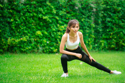 Full length of woman sitting on grass