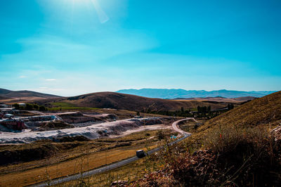 Scenic view of landscape against blue sky