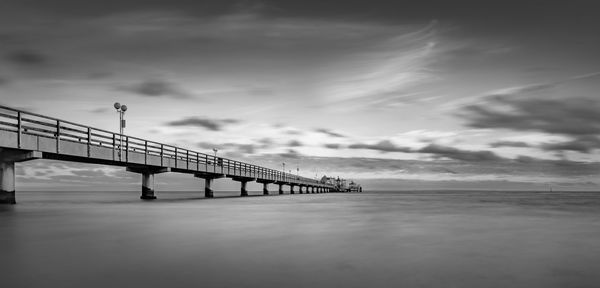 Bridge over sea against sky