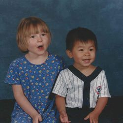 Smiling siblings looking away