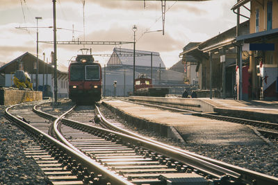 Train at railroad station against sky