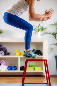 Box jumps. woman jumping on jump stool during training.