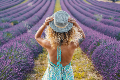 Rear view of woman standing on field