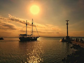 Silhouette sailboat on sea against sky during sunset