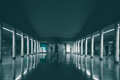 People walking in illuminated building