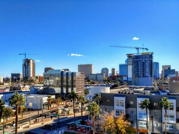 Buildings in city against blue sky