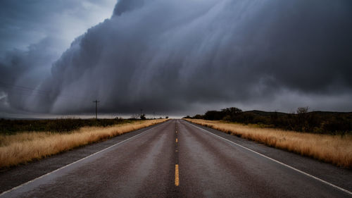 Empty road along countryside landscape