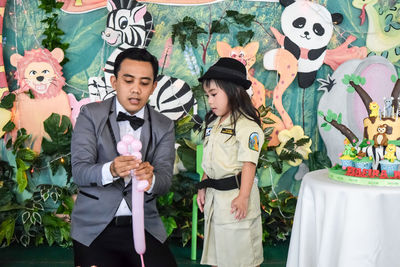 Young couple standing by flowers