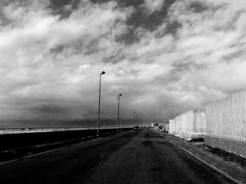 Road by street against sky