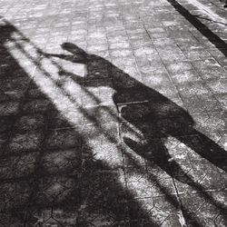 Shadow of people on street