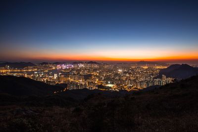 High angle view of illuminated buildings against sky at sunset