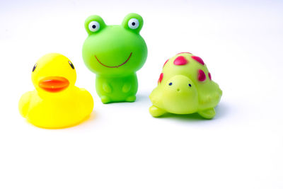 Close-up of yellow toys against white background