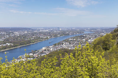 Scenic view of landscape and city against sky