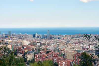 High angle view of townscape by sea against sky