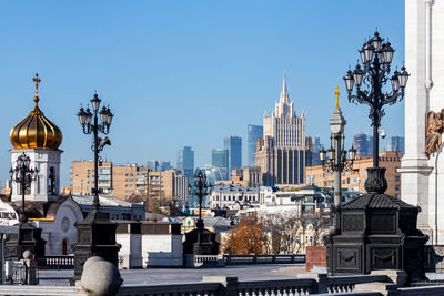 View of buildings in city against clear sky