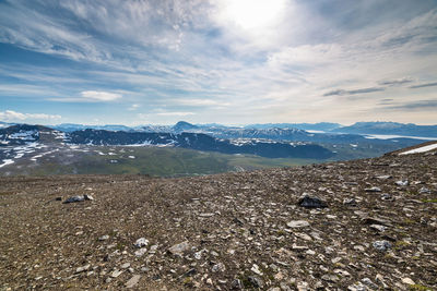 View of calm sea against mountain range