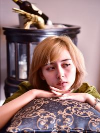 Portrait of beautiful young woman sitting at home