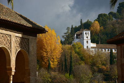 Panoramic view of trees and buildings against sky