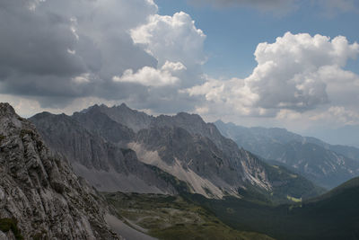 Scenic view of mountains against cloudy sky