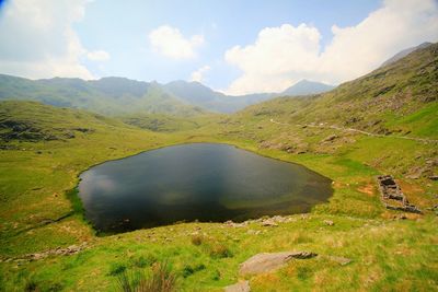 Scenic view of lake and mountains against sky