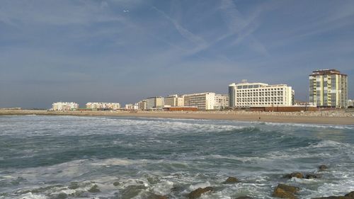 View of calm sea against buildings