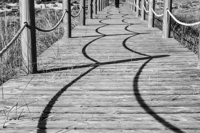 Shadow of railing on footpath