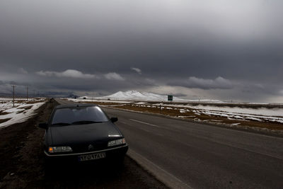 Car on road against sky during winter