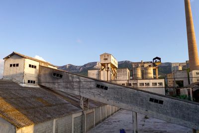 Low angle view of buildings against clear blue sky