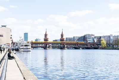 Bridge over river with city in background