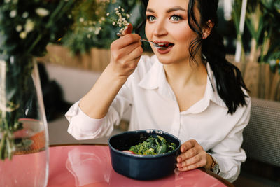 Young woman sitting at restaurant table