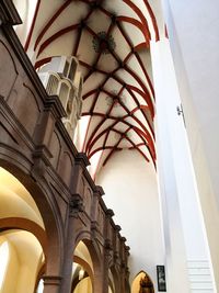 Low angle view of illuminated lamp in building