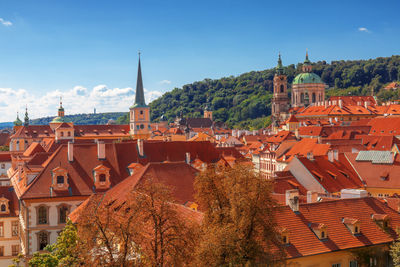 Red rooftops of lesser quarter of prague under blue summer sky. 