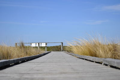 Boardwalk against clear sky