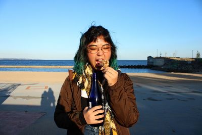 Young woman standing at beach