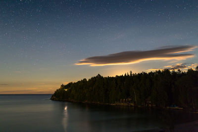 Scenic view of sea against sky at night