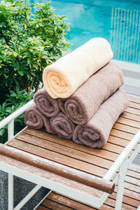 High angle view of stacked towels on table at poolside