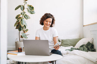 Young woman using laptop at home