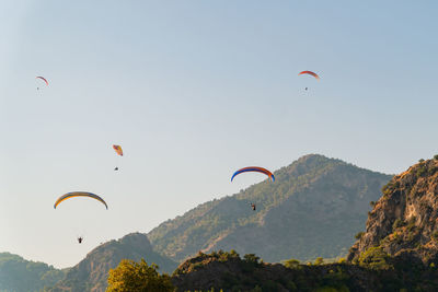 People paragliding against sky