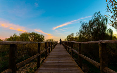 Pier on footbridge against sky