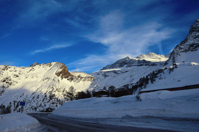 Scenic view of snow covered mountains against sky