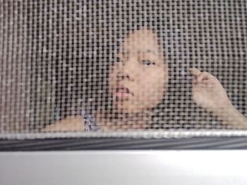 Close-up of man looking through window