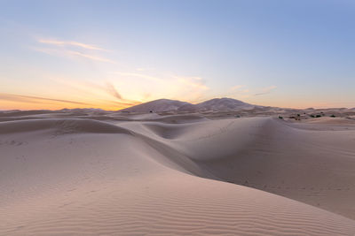 Scenic view of desert against sky during sunset