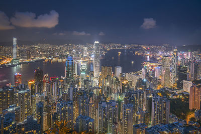 Aerial view of illuminated cityscape against sky at night