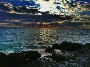Scenic view of sea against cloudy sky