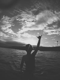 Man hand on sea against sky