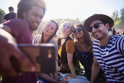 Man taking selfie with friends in party