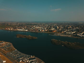 High angle view of river and buildings against sky