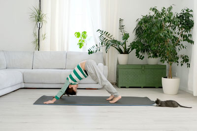 Boy exercising on mat at home